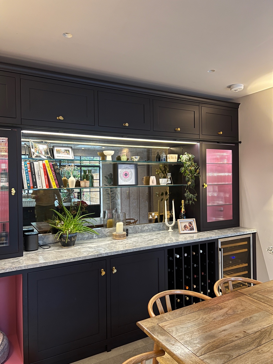 Bespoke drinks cabinet with mirrored back, wine rack, and wine cooler